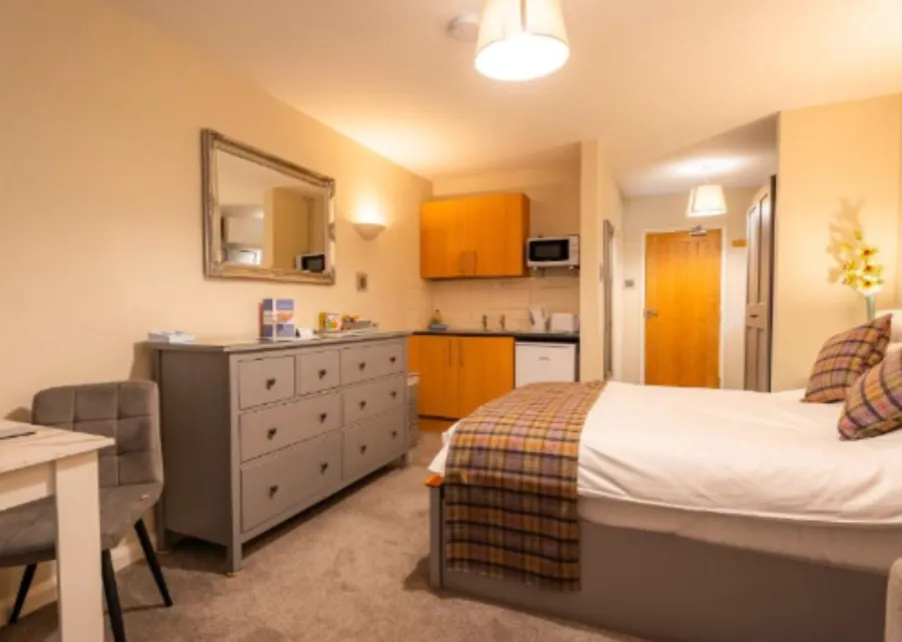 Red-accented luxury bedroom with modern workspace at Blueberry Lets